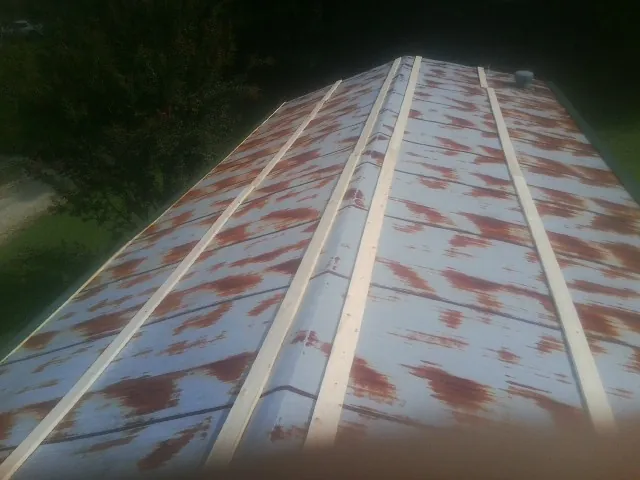 Rusted metal roof panels with new wood purlins before replacement — Storm Damage Roof Repair in Fromberg by Roofing Brothers